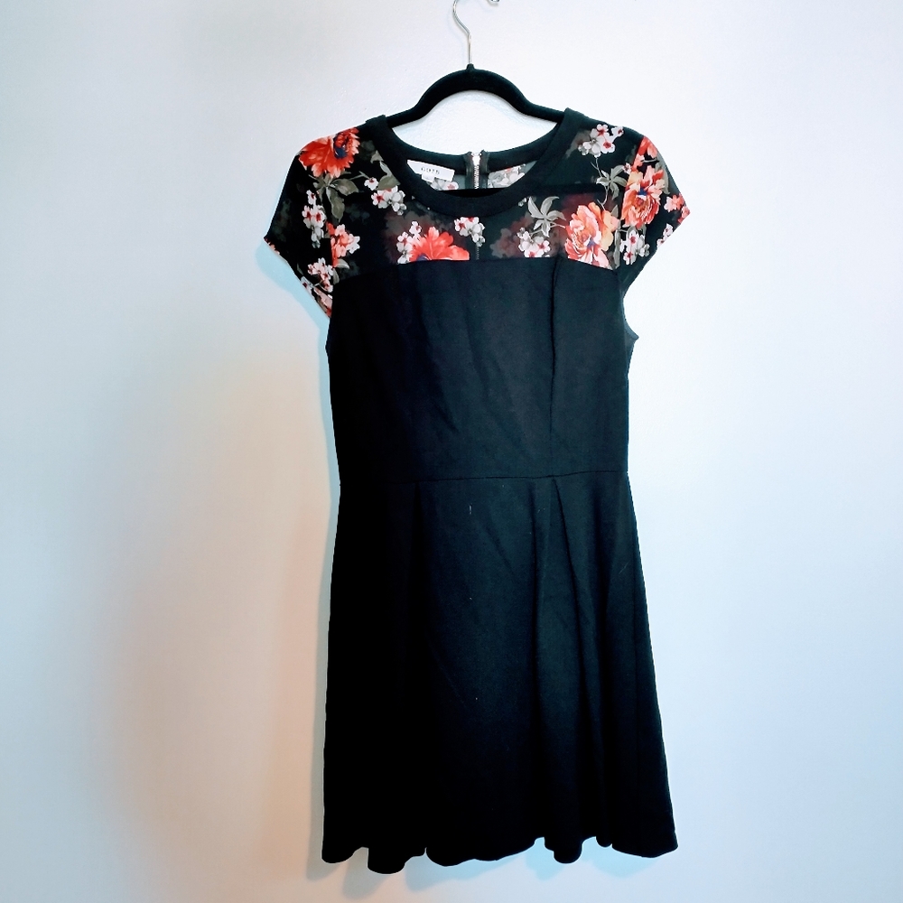 OOTD black for and flare dress with sheer floral pattern neckline. Short cap sl